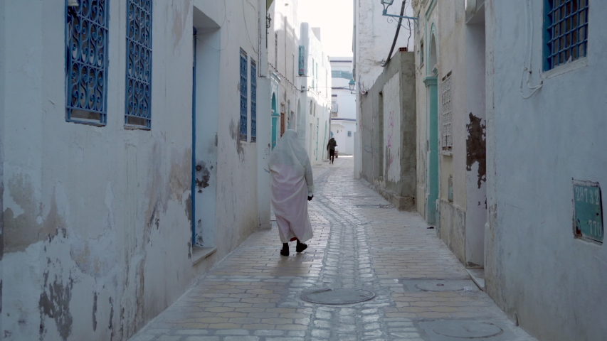 Old women is walking on Tunisian Old street, Kairouan, Tunisia, North Africa
 | Shutterstock HD Video #1053377117