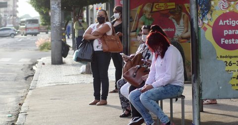 SAO PAULO, BRAZIL, Circa May 2020;  bus stop during a coronavirus pandemic, covid 19, people in medical mask 