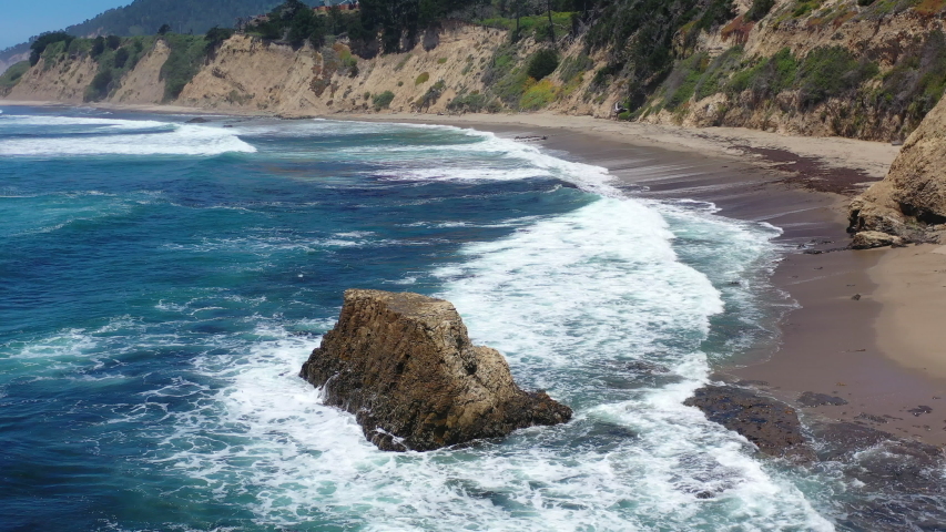 The cold water of the Pacific Ocean washes against the rugged coastline not far from Santa Cruz, California. This area, south of San Francisco, is known for its great surfing and gorgeous beaches.