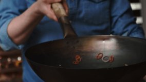 Close up video of chef tossing the dish in the pan. Shot with RED helium camera in 8K