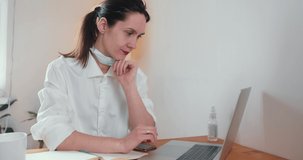 Beautiful happy 30s brunette Caucasian doctor woman giving advice online on web conference from home using laptop.