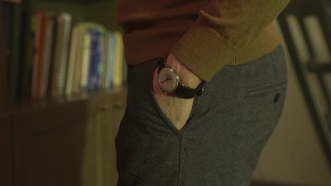 Man hand in pants pocket closeup unrecognizable man old vintage wristwatch slow motion camera movement