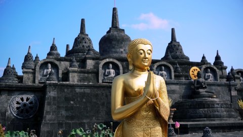 golden buddha in front of indonesian temple in 4k