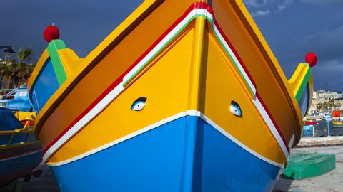 Traditional fishing boat decorated with Osiris eyes in the harbour of the fishing village of Marsaxlokk in Malta Island of Malta, Europe