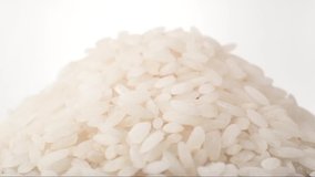 Rice grains of spin around themselves on white background