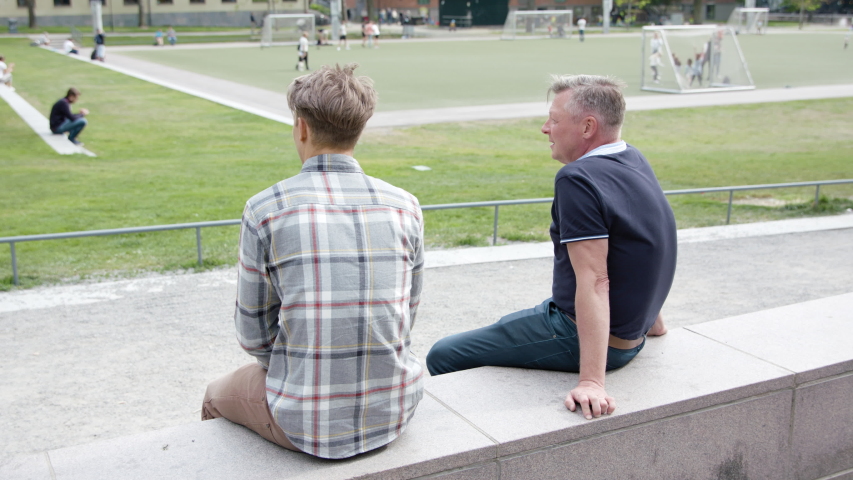 Two colleagues hanging out in a park during coronavirus pandemic.
