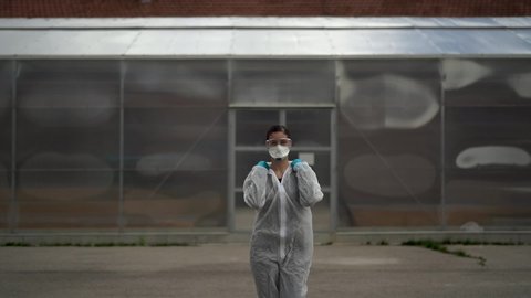 Equipped doctor waiting for patients in front of isolation ward medical facility.Coronavirus COVID-19 physician in PPE.City infectologist.Medical worker on the frontline	