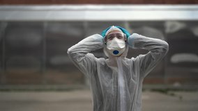 Exhausted crying doctor/nurse in coronavirus protective gear N95 mask.Covid-19 pandemic outbreak.Fatalities grief.Frontline worker mental stress,burnout.Mental breakdown.Overworked healthcare provider - Powered by Shutterstock - Get 15% off with code: PIKWIZARD15
