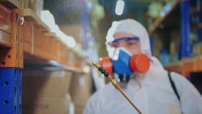 Man Disinfecting Warehouse. Covid-19. Corona Virus Disinfection. Antiseptic Sanitizer. Coronavirus Disinfectant. Worker Wear White Uniform Suit. Protect Mask. Spray Disinfecter. Covid 19 Sanitizing. - Powered by Shutterstock - Get 15% off with code: PIKWIZARD15
