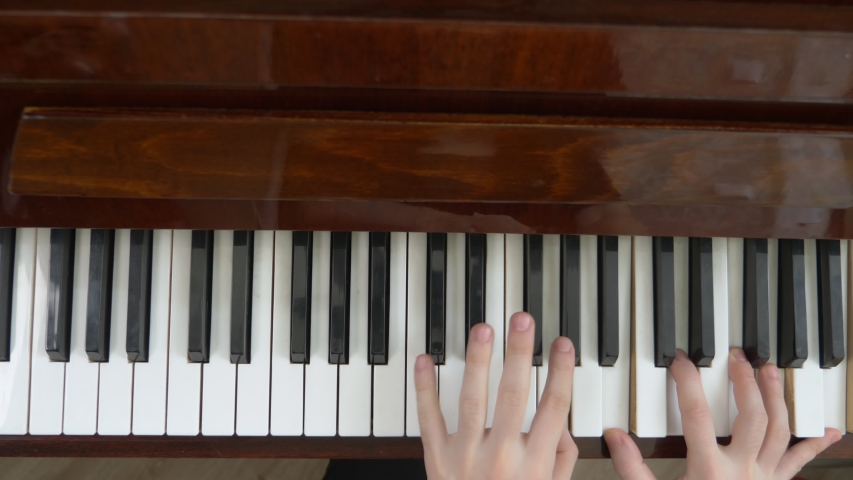 closeup. female hands masterfully play the arpeggio on the piano. the view from the top. Royalty-Free Stock Footage #1053420731