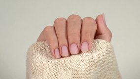 Closeup view 4k video footage of two beautiful freshly manicured female hands isolated on white background.