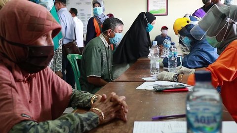 Elderly people do the coronavirus test. Doctors with protective suits draw blood and check body temperature. Non-invasive testing method. Rapid test Covid, Batang Indonesia, May 27, 2020