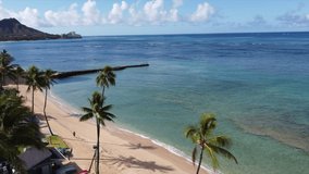 Cinematic aerial drone videos of vacant Waikiki Beach, amidst the backdrop of iconic Diamond Head.