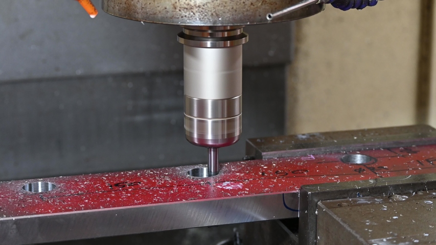 Operation of CNC milling machine bore cutting hole on the metal plate by solid endmill tool. The hi-technology machining concept by machining center. 