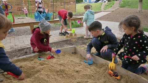Chisinau, Moldova, May 27th, 2020: Preschool children playing together in sandbox in residential area, as some of COVID-19 restrictions decreased and lockdown was cancelled.