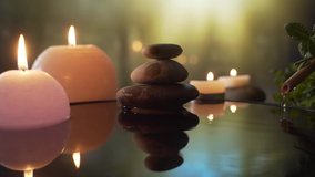 
burning candles in the water, the reflection of stones on the background of evening nature, water drops falling. slow motion. Close up Concept: relaxation, wellness, body care, spa, aromatherapy - Powered by Shutterstock - Get 15% off with code: PIKWIZARD15