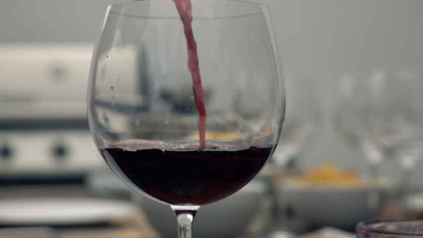 Red wine pouring to the glass super slow motion | Shutterstock HD Video #1053441599