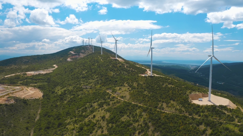 Aerial panoramic view of windmills in the hills. Amazing blue sky with white clouds on the background. Montenegro | Shutterstock HD Video #1053442619