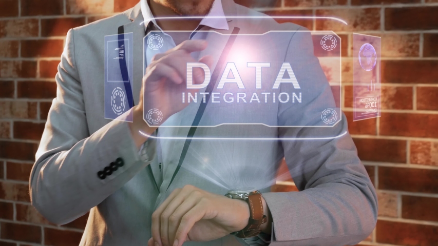Unrecognizable businessman activates conceptual HUD holograms on smartwatch with text Data integration. Man in jacket with holographic technology on wristwatch on background of brick wall - Powered by Shutterstock - Get 15% off with code: PIKWIZARD15