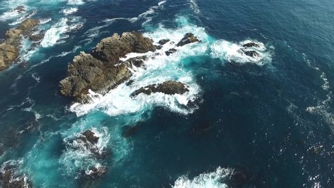 Aerial over waves crashing on rocks. Big Bur, California, USA.