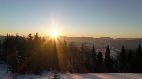 Winter in Carpatian mountains, beautiful sunset landscape with a bird's eye view, UHD 4K