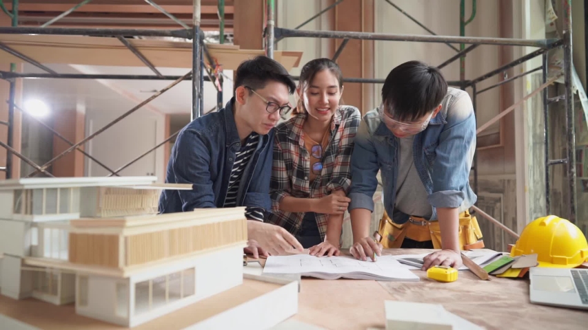 Serious discussion scene of Asia architects planning of house renovation with blueprint indoor, working confliction, home interior designer, home improvement, real estate development industries. Royalty-Free Stock Footage #1053448889
