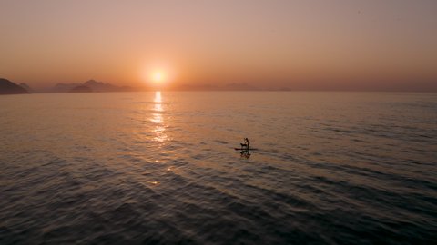 Drone Shot of a Woman Doing Stand Up Paddle with a Dog in Sunrise in the Sea of  Copacabana Beach with Sugar Loaf at Background, Rio de Janeiro - Brazil 