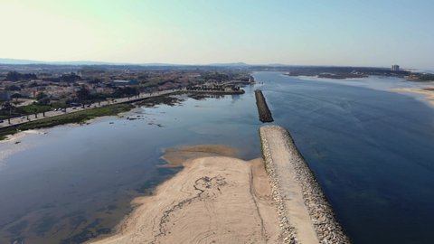 DRONE The two sides of Restinga de Ofir. One facing the ocean, the other the estuary of Cávado River. The jetty structure that protects the coastline from the currents and tides in Esposende, Portugal