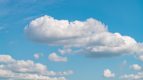 Blue sky white clouds. Puffy fluffy white clouds. Cumulus cloud scape timelapse. Summer blue sky time lapse. Dramatic majestic amazing blue sky. Soft white clouds form. Cloud time lapse background 4K