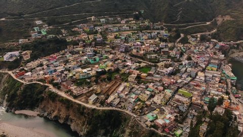 4K Aerial view of a Himalayan city and valley of  Satpuli, Uttarakhand, India. Situated amongst the mountains with a River stream flowing by. Drone shot