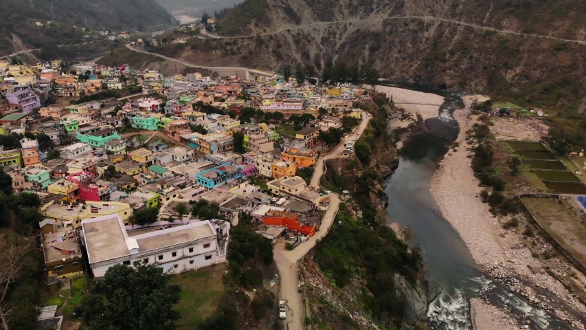 4K Aerial view of a Himalayan city and valley of  Satpuli, Uttarakhand, India. Situated amongst the mountains with a River stream flowing by. Drone shot | Shutterstock HD Video #1053476294