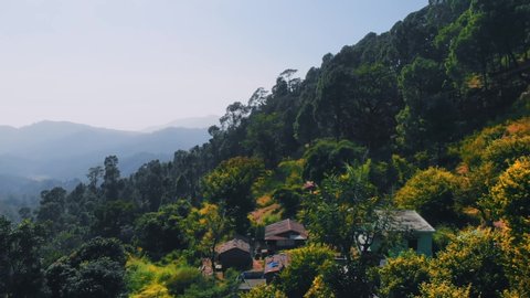 4K Aerial View of a Himalayan Hilltop Surrounded by Greenery and Blue Sky. Cinematic Drone Shot of a Hilly Place called George Everest in Mussoorie, Uttarakhand, India. 