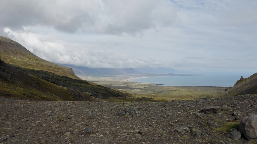 Aerial drone shot flying over beautiful Icelandic nature with coastline and ocean in distance. View from sky over rocky landscape full of rocks, stones. Adventurous trek in Snaefellsnes area, Iceland