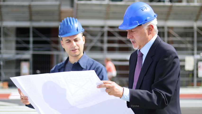 two architect developers reviewing building plans Stock Footage Video ...