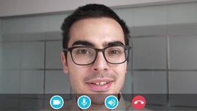 Man using a viideo calling mobile app with icons, to chat and have a conversation from his home