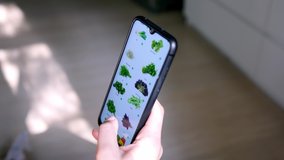 Man at home in the living room using a smartphone shopping in the online store. A man orders food home in an online store using a smartphone.  - Powered by Shutterstock - Get 15% off with code: PIKWIZARD15