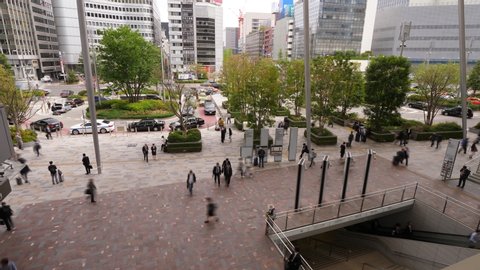 TOKYO - APRIL 06, 2018: Yaesu Central Entrance of Tokyo Station, time lapse shot at day time. Quick moving commuters figures, people walk around central transportation hub of city