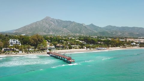 Beautiful and unique cinematic aerial view of luxury and exclusive area of Marbella, golden mile beach, Puente Romano Bridge.Luxury Clubs, Urbanisation in the most expensive area of Marbella. Forward