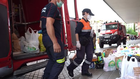 GRANADA, ANDALUSIA, SPAIN, MAY 31ST, 2020 Firefighters collecting food and basic necessities for victims of poverty from the Covid-19 pandemic.