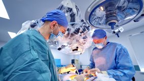 Surgeons working in operating room.. Surgeons working in operating room. Hospital background. Two male doctors at work. Circular background of an operation on a spinal cord, vertebra. - Powered by Shutterstock - Get 15% off with code: PIKWIZARD15