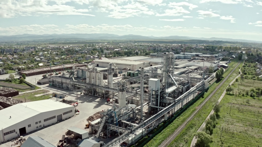 Aerial drone view. Factory industrial zone, wood processing factory warehouses, workers inside the factories area with margins in the background Royalty-Free Stock Footage #1053509294
