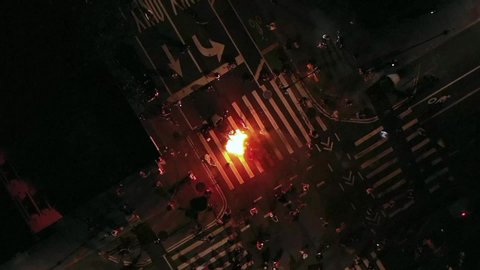 NEW YORK - MAY 30, 2020: protestors lighting fire in crosswalk intersection after police officers killed George Floyd, people take to the streets in New York City NYC.