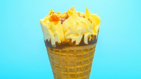blueberry and cheese flavor ice cream cone melting timelapse on blue background at 8K
