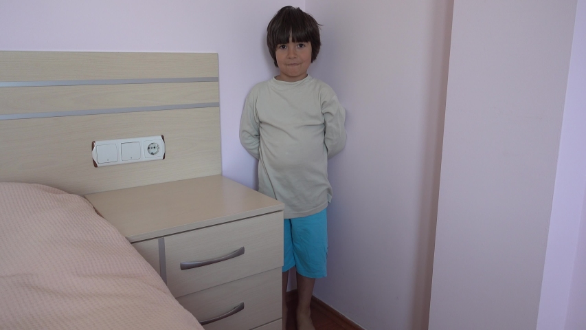 4K Naughty boy being put in the corner is smiling, crystal child
