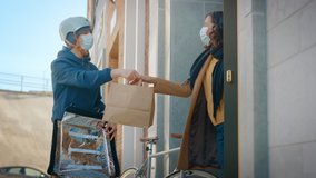 Food Delivery Man Wearing Protective Medical Face Mask and Thermal Backpack Rides a Bike to Deliver Order to a Masked Female Customer. Courier Delivers Takeaway Lunch. Quarantine, Social Distancing - Powered by Shutterstock - Get 15% off with code: PIKWIZARD15
