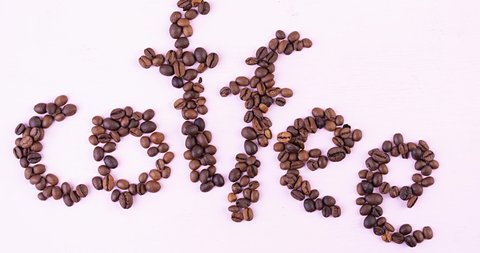 Coffee beans line up in the word coffee