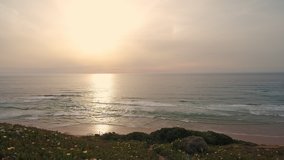 Aerial video shooting. Beautiful sunset, sunrise, which is reflected in the ocean. Arrifana Beach, Sagres, Portugal, Algarve.