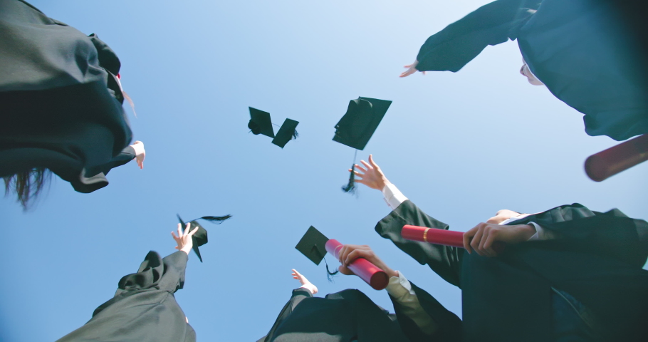 Slow motion of group happy graduates students throw their caps into the air | Shutterstock HD Video #1053543557