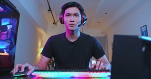Young Asian Handsome Pro Gamer Playing in Online Cyber Sport Game at home