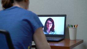 Young woman using laptop at home for distance education
